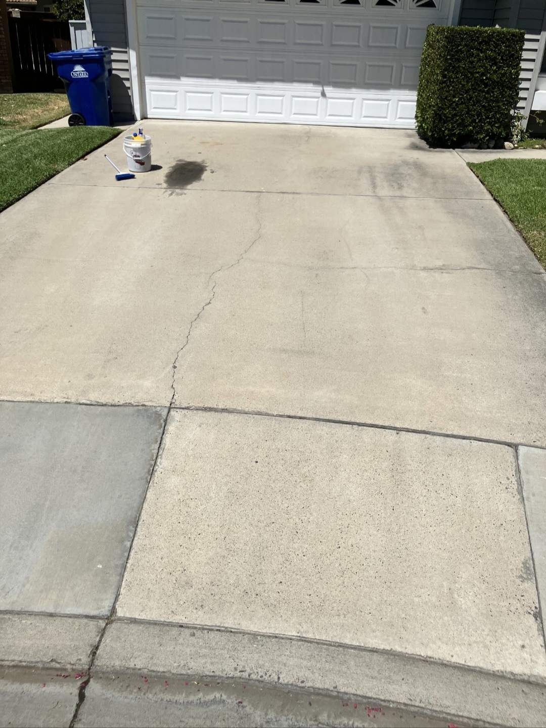 Driveway oil stain before pressure washing and stain removal
